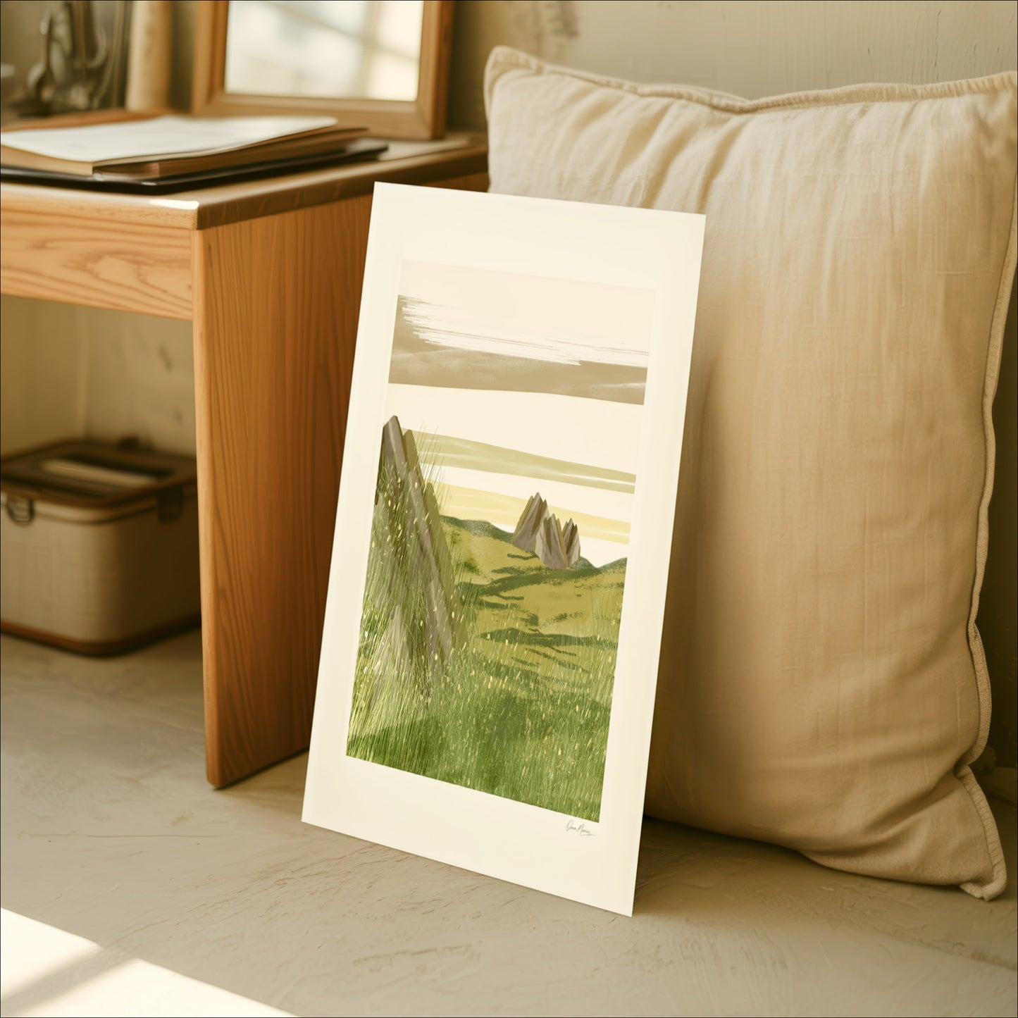 Open Field art print leaning against a sofa cushion in a cozy Scandinavian interior, OAM Studio