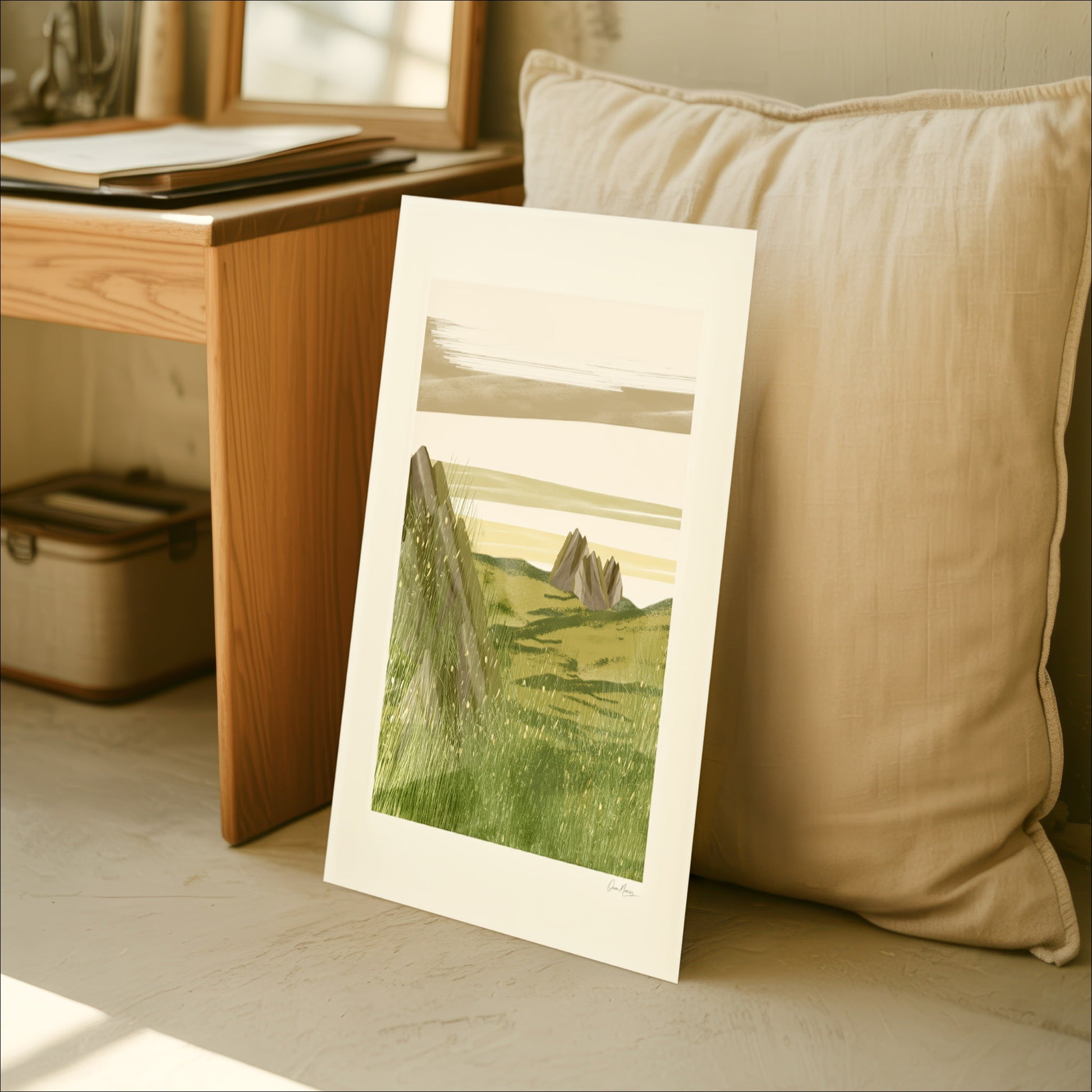 Open Field art print leaning against a sofa cushion in a cozy Scandinavian interior, OAM Studio