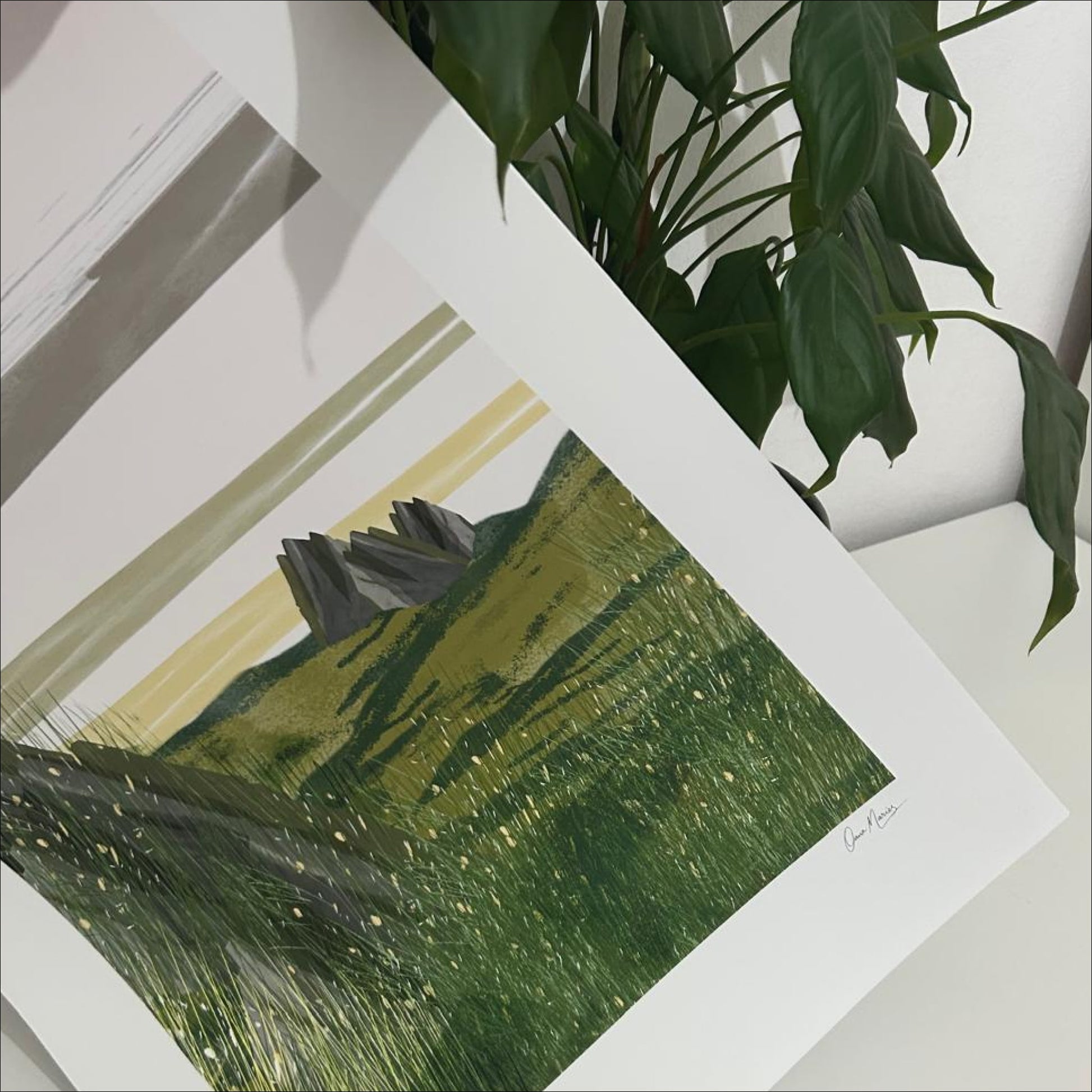 Open Field art print framed in a bright living room with a person holding coffee, OAM Studio