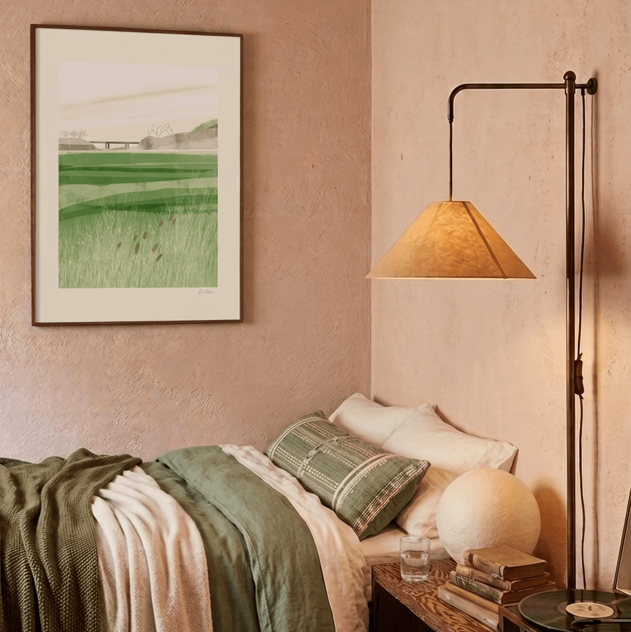 Bedroom with a lamp, pillows, and a painting on the wall.