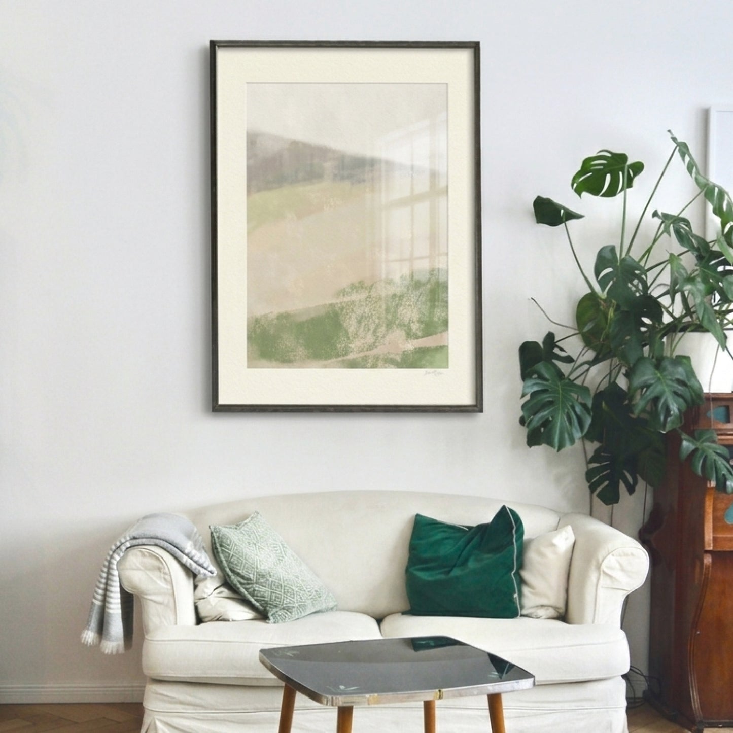  print art Living room with a white sofa, framed artwork, and a plant.oam studio print art